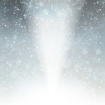 Falling Snow On The Grey Background With Light Stock Photo