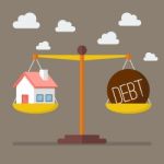 House And Debt Balance On The Scale Stock Photo