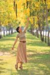 Portrait Of Beautiful Young Asian Woman Relaxing In Flowers Park Stock Photo