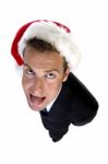 Businessman Wearing Santa Cap And Teasing With Tongue Stock Photo