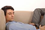 Man Sleeping On The Couch Stock Photo