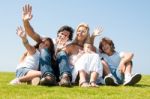 Happy Family Relaxing In Garden Stock Photo