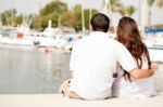 Couple Seated On Footbridge Stock Photo