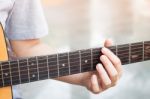 Woman's Hands Playing Acoustic Guitar Stock Photo