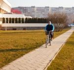 Elderly Man Wearing Glasses Riding A Bicycle Stock Photo