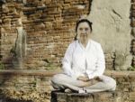 Buddhist Woman Meditating Stock Photo