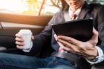 Young Handsome Businessman Working In Back Of Car And Using A Ta Stock Photo