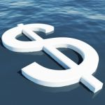 Dollar Floating On Sea Stock Photo