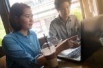 Freelance Workers Working Together In Cafe Stock Photo