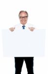 Senior Marketing Manager Holding Up A Blank Ad Board Stock Photo