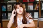 Portrait Of Thai Adult Student University Uniform Beautiful Girl Using Her Smart Phone Stock Photo