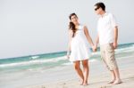 Couple Walking On The Beach Stock Photo