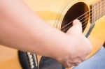 Guitarist Hand Playing Acoustic Guitar Stock Photo