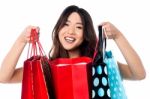 Pretty Young Chinese Girl Holding Shopping Bags Stock Photo