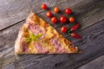 Pizza On Wooden Table, Cherry Tomato And Hot Peppers Stock Photo