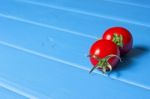 Fresh Tomatoes On The Blue Wooden Table Stock Photo