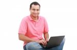 Man Sitting On Floor With Laptop Stock Photo