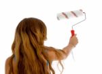 Back Pose Of Girl With Roller Brush Stock Photo