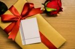 Blank Card On Ribbon Gift Box And Red Rose Stock Photo