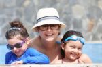 Happy Mother With Her Kids In The Pool Stock Photo