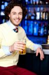 Young Man Holding A Glass Of Beer Stock Photo