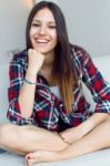 Beautiful Young Woman Looking At Camera At Home Stock Photo