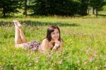 Girl Lying On The Grass In The Park Stock Photo