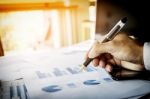 Business Man Working At Office With Laptop, Tablet And Graph Dat Stock Photo