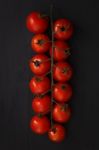 Organic Fresh Cherry Tomatoes On Black Board Background Stock Photo