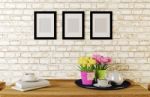 Coffee Served On Table In White Brick Room Decorated With Photo Frames Stock Photo