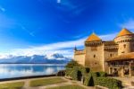 Castle By A Lake Front On A Blue Day Stock Photo