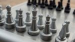 Light And Dark Wooden Chess Pieces On Chess Table Stock Photo