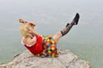 Woman Playing On Cliff Stock Photo