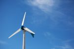 Green Renewable Energy Concept - Wind Generator Turbines On Blue Stock Photo