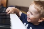 Small Boy Enjoys Playing Electric Piano Stock Photo