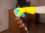 Woman Cleaning A Guitar With A Rag Stock Photo