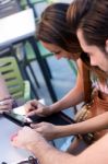 Couple Of Young Students Using A Digital Tablet In The Bar Stock Photo