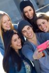 A Group Of Friends Taking Photos With A Smartphone Stock Photo