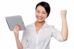 Excited Businesswoman Holding Touch Pad Stock Photo