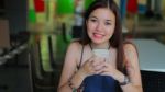 Portrait Of Thai Adult Beautiful Girl Using Her Smart Phone And Smile Stock Photo