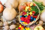 Basket With Halloween Candy And Autumn Decorations Stock Photo