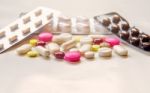 Top View Of The Pills On The White Background, Pack Of Tablet Drug And Capsule Pills On The Floor Stock Photo