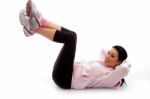 Side View Of Smiling Exercising Female On White Background Stock Photo