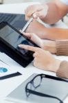 Executive Hands With Digital Tablet In A Financial Meeting Stock Photo