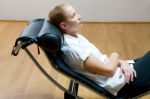 Woman Lying On Chaise Longue Stock Photo