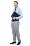 Handsome Confident Businessperson Holding File Folder Stock Photo