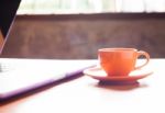 Coffee Cup With Keyboard On Wooden Table Stock Photo