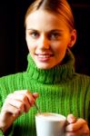 Young Woman Drinking Cappuccino Stock Photo