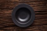 Black Empty Bowl On Wooden Table Background Stock Photo