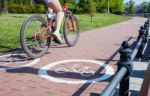 Girl Bicyclist Riding On The Bike Path Stock Photo